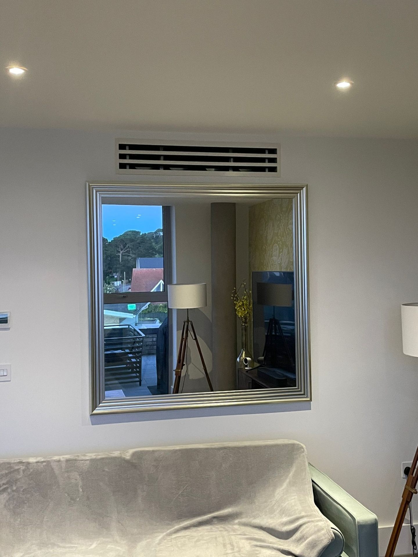 Ducted AC vent above mirror in living room