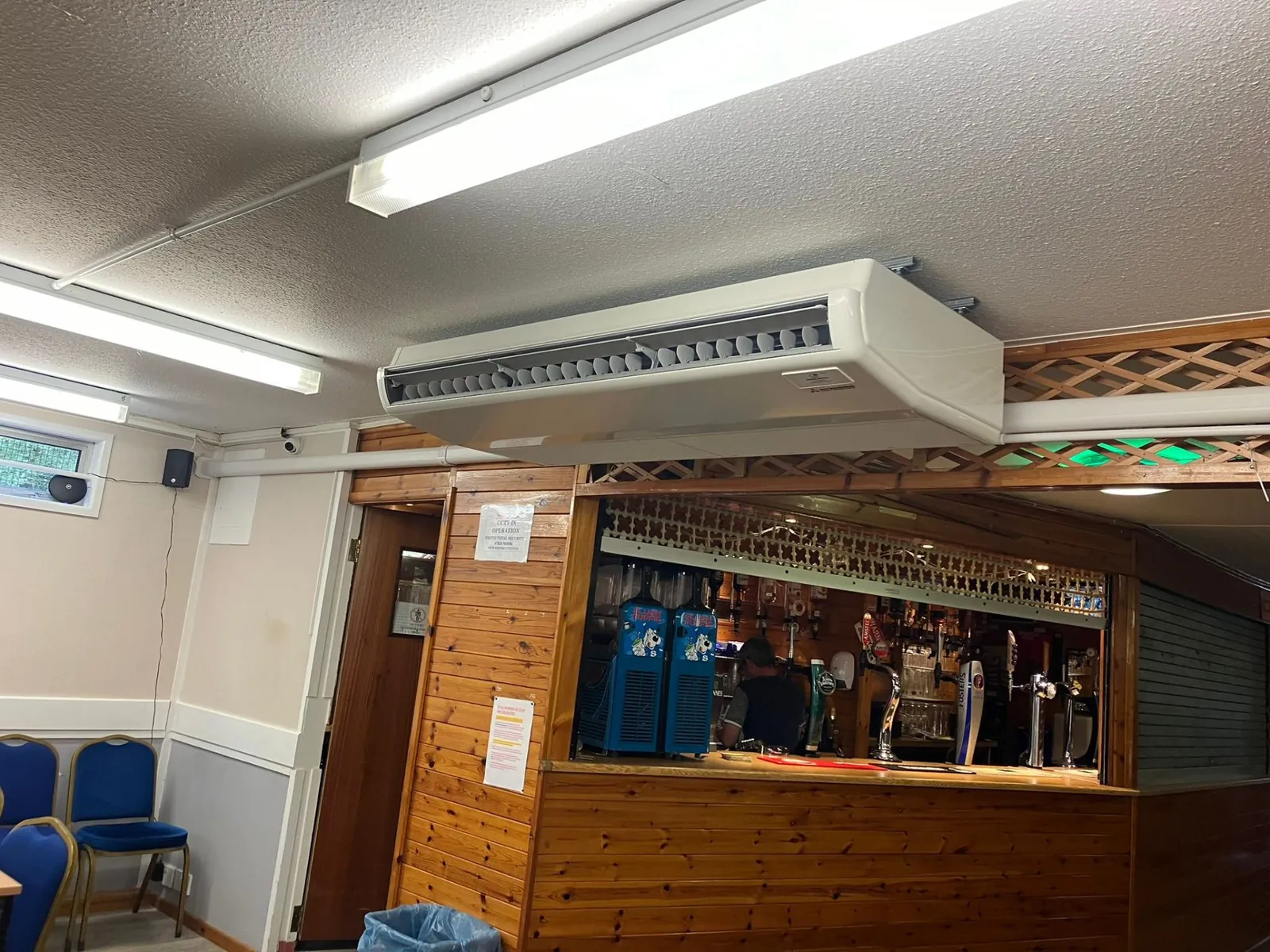 Ceiling-mounted AC unit installed in bar area