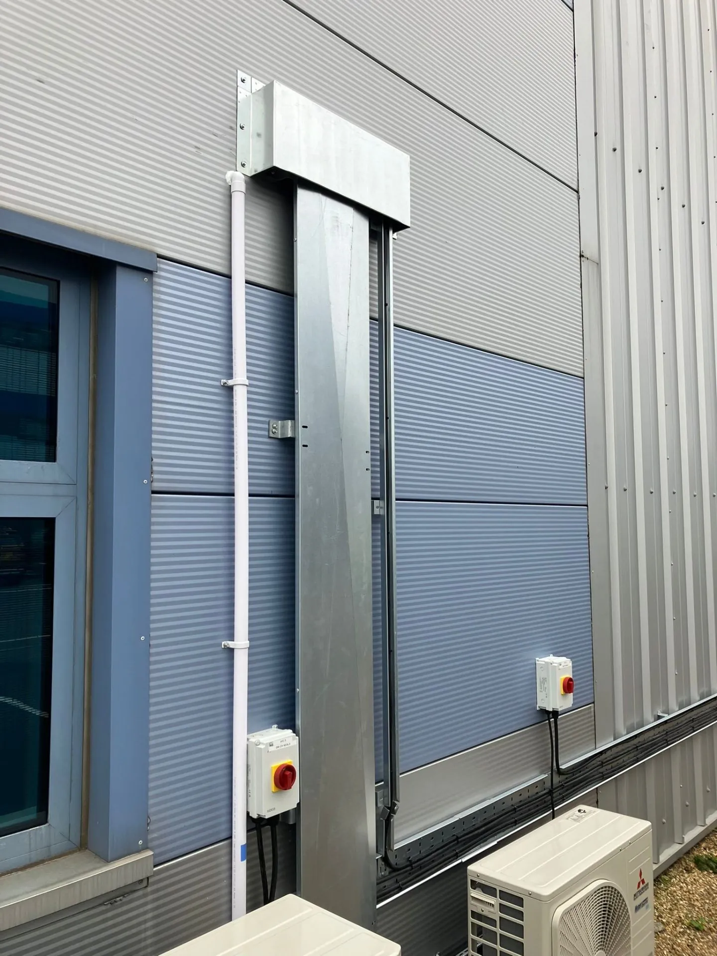 Commercial AC pipework and isolator switches on cladding