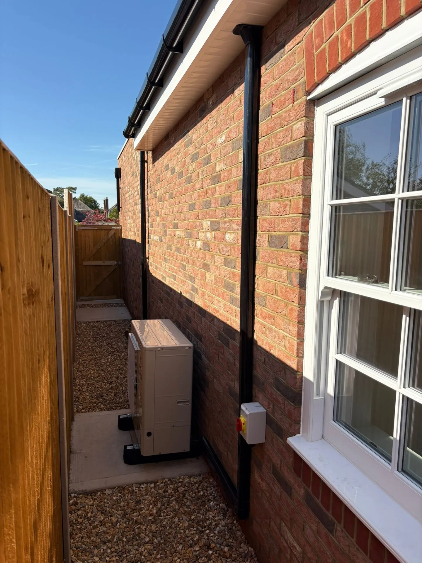 Outdoor condenser with pipework on residential property