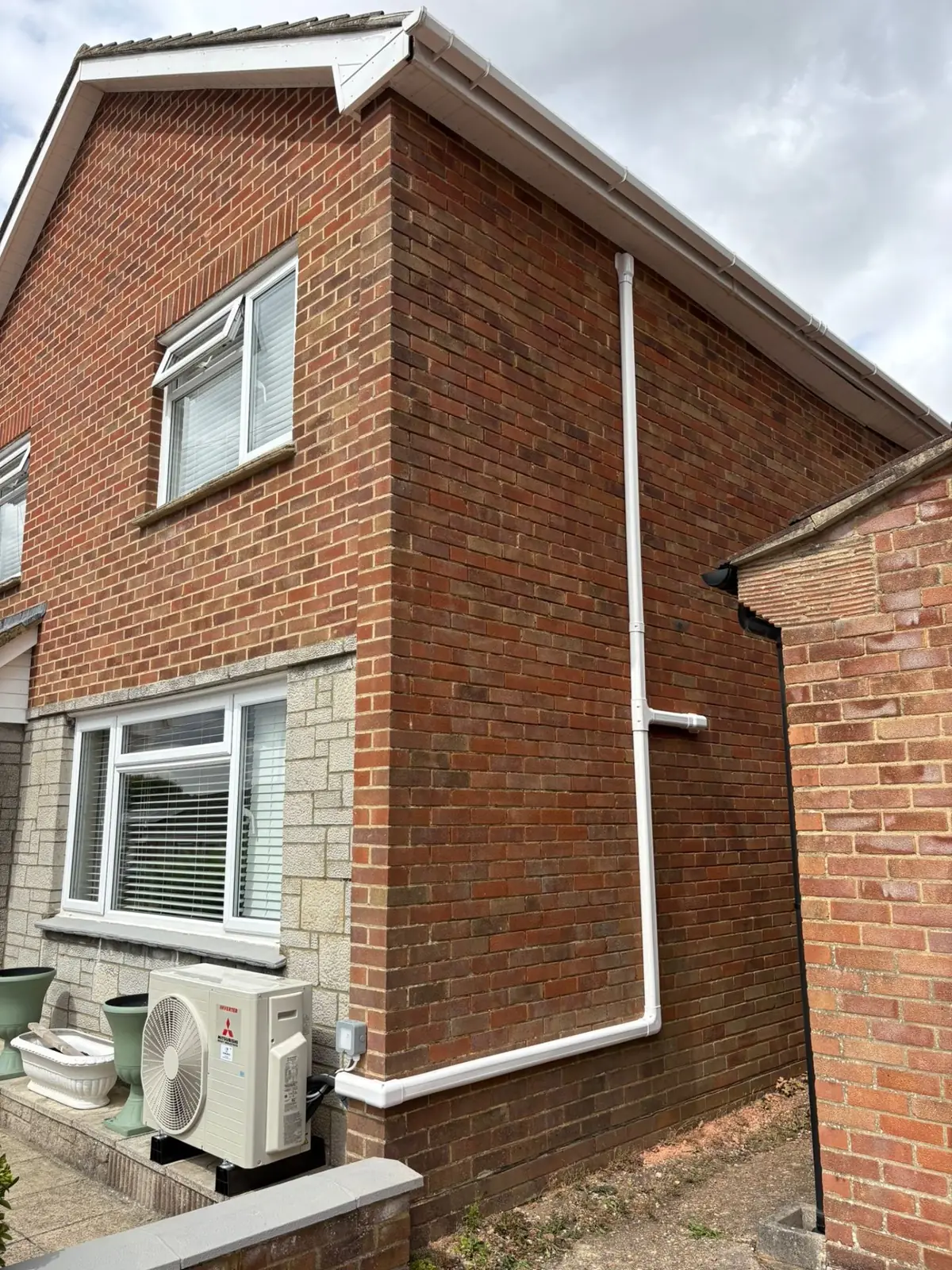 Mitsubishi outdoor unit with trunking on house