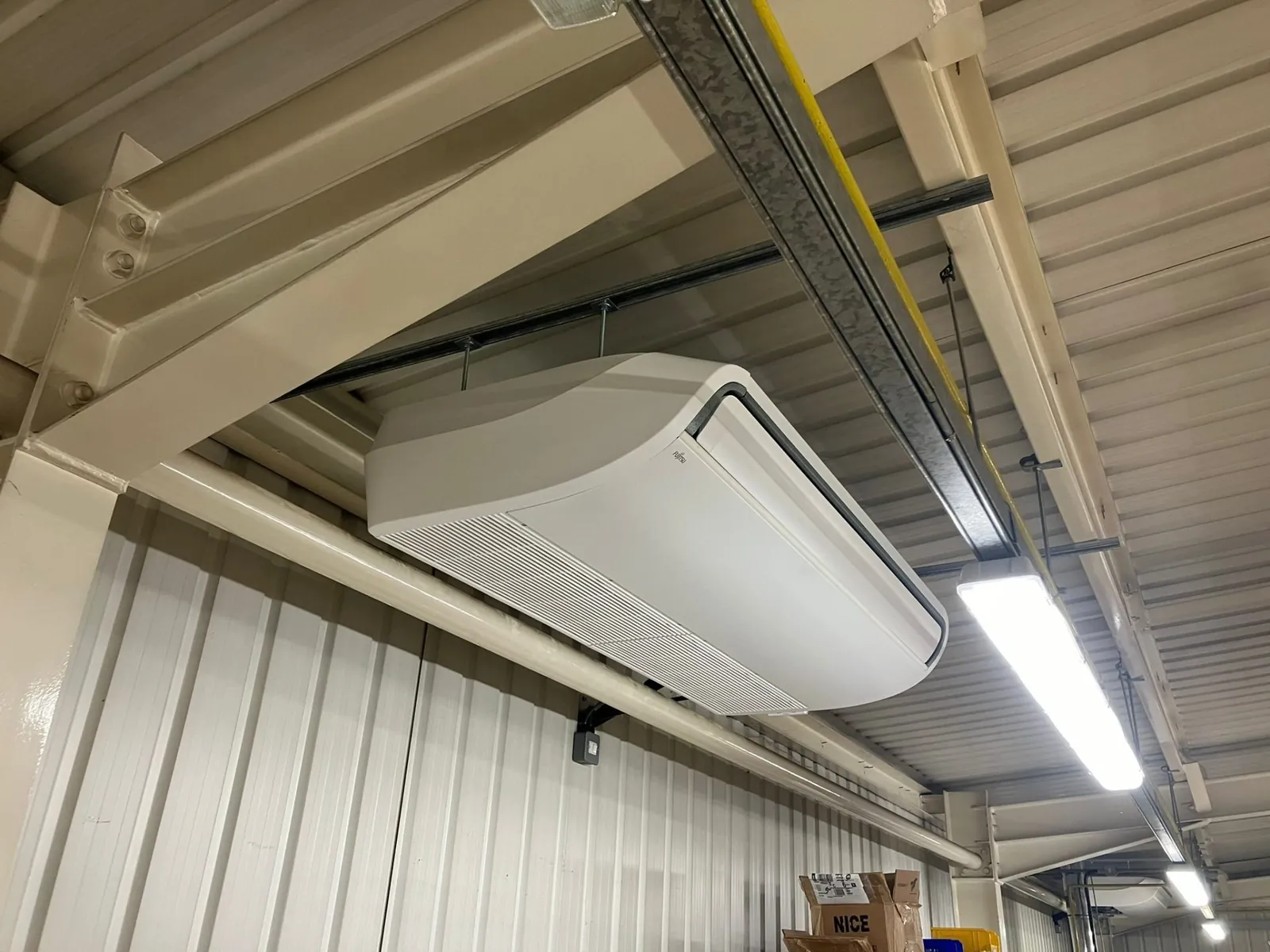 Commercial ceiling-suspended AC unit in warehouse