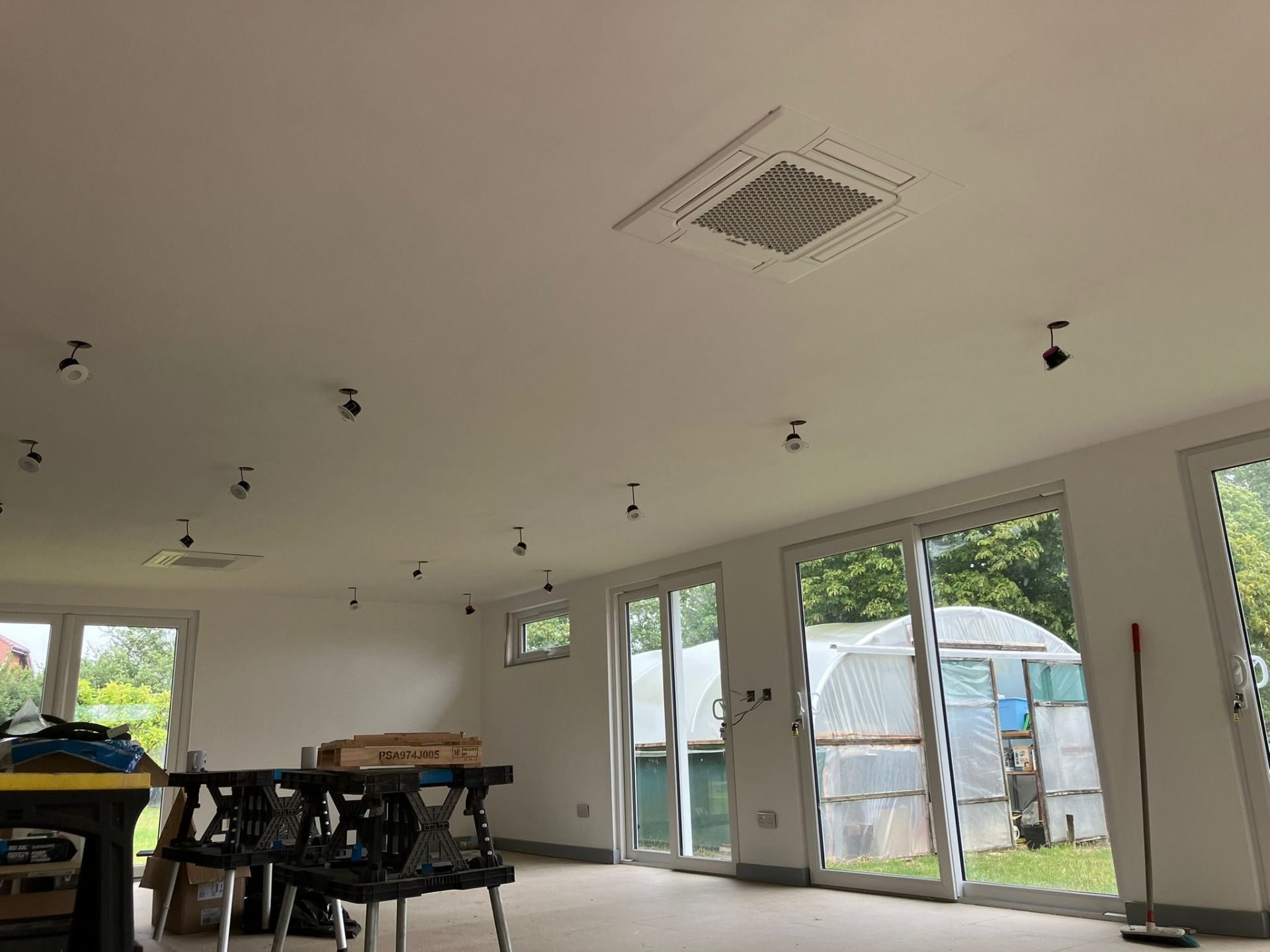 Ceiling cassette AC unit in modern workspace